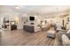 Spacious living room featuring light wood floors, a fireplace, and built-in shelving at 4018 Moxie Way, Charlotte, NC 28215
