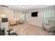 Inviting living room features plush carpet, bright windows and comfortable seating at 4018 Moxie Way, Charlotte, NC 28215