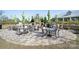 Outdoor kitchen area featuring grills, a fireplace, dining tables, and umbrellas at 4018 Moxie Way, Charlotte, NC 28215