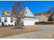 Charming home featuring white siding, a well-maintained lawn, and an attached garage at 4039 Highgate Ln, Lancaster, SC 29720