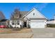 Attractive home with white siding, stone accents, a well-kept lawn, and attached garage at 4039 Highgate Ln, Lancaster, SC 29720