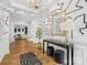 Bright foyer with artistic wallpaper, wood floors, modern chandelier, console table, and view to formal living spaces at 4039 Highgate Ln, Lancaster, SC 29720