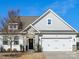 Charming two-story home featuring stone accents, gray siding, manicured landscaping, and an attached two-car garage at 4039 Highgate Ln, Lancaster, SC 29720