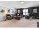 Cozy living room featuring a large leather sectional, ottoman, and dark accent wall at 4039 Highgate Ln, Lancaster, SC 29720