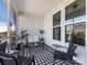 Cozy screened-in porch with modern furniture and a stylish black and white checkered rug at 4039 Highgate Ln, Lancaster, SC 29720