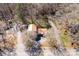 Aerial view showcases a brown roof home with a detached garage, surrounded by lush greenery and a private driveway at 4919 Rehobeth Rd, Waxhaw, NC 28173