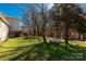 Expansive backyard with healthy green grass and mature trees, including a propane tank at 4919 Rehobeth Rd, Waxhaw, NC 28173
