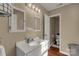 White single sink bathroom with wood-look floors and updated hardware, and adjacent toilet area at 4919 Rehobeth Rd, Waxhaw, NC 28173