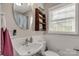 Charming bathroom features a round mirror, decorative shelving, and beadboard paneling at 4919 Rehobeth Rd, Waxhaw, NC 28173