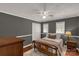 Bedroom with two windows, fan, wood floors, tan bedspread, and grey walls at 4919 Rehobeth Rd, Waxhaw, NC 28173