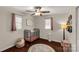 Bedroom with a metal crib, wood floors, two windows, overhead fan, and soft rug at 4919 Rehobeth Rd, Waxhaw, NC 28173
