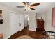 Bedroom features a ceiling fan, wood floor, closet, dresser and neutral paint at 4919 Rehobeth Rd, Waxhaw, NC 28173