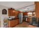 A well-lit kitchen features stainless steel appliances, wood cabinets, and tiled floors at 4919 Rehobeth Rd, Waxhaw, NC 28173
