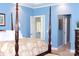 Comfortable main bedroom featuring a four-poster bed and ensuite bathroom access at 522 Sarazen Way, Salisbury, NC 28144
