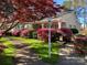 Inviting home exterior showcasing a lovely red tree, lush landscaping, and a well-maintained walkway at 536 S Union S St, Concord, NC 28025