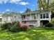 Charming home exterior with a balcony overlooking a beautiful backyard and blooming azaleas at 536 S Union S St, Concord, NC 28025