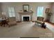 Bright living room with a fireplace, neutral carpet, and comfortable seating, perfect for relaxation at 536 S Union S St, Concord, NC 28025