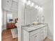 Bright bathroom featuring double sinks with granite countertops and modern cabinets at 554 Amalfi Dr, Davidson, NC 28036