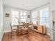 The sunlit dining room features hardwood floors and modern light fixtures at 554 Amalfi Dr, Davidson, NC 28036