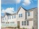 Charming end-unit townhouse with modern siding, bright windows, and well-manicured landscaping at 554 Amalfi Dr, Davidson, NC 28036