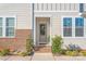 Charming front entrance with brick steps, gray door, and a welcoming wreath at 554 Amalfi Dr, Davidson, NC 28036