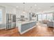Bright, updated kitchen with stainless steel appliances, a center island, and views of the living area at 554 Amalfi Dr, Davidson, NC 28036