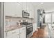 Bright kitchen boasts stainless steel appliances, marble countertops, and white cabinetry at 554 Amalfi Dr, Davidson, NC 28036