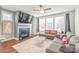 Comfortable living room with a fireplace, large windows, and modern decor at 554 Amalfi Dr, Davidson, NC 28036