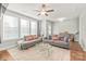 Bright living room featuring hardwood floors, a ceiling fan, and large windows at 554 Amalfi Dr, Davidson, NC 28036