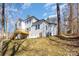 Backyard view of white house with a wooden deck and stairway at 606 Saint Cloud Dr, Statesville, NC 28625