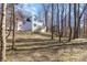 Exterior of the house showing a deck and white siding surrounded by a wooded area at 606 Saint Cloud Dr, Statesville, NC 28625