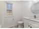 This bathroom showcases modern fixtures, a white vanity, and natural light from the window at 606 Saint Cloud Dr, Statesville, NC 28625