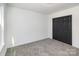 Carpeted bedroom with a dark double door closet and white walls at 606 Saint Cloud Dr, Statesville, NC 28625