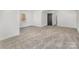 Spacious bedroom with neutral carpeting, a window, and a dark-colored interior door at 606 Saint Cloud Dr, Statesville, NC 28625
