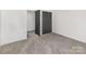 Bedroom featuring neutral carpet and a dark double door closet at 606 Saint Cloud Dr, Statesville, NC 28625