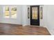 Charming foyer featuring a stylish front door, hardwood flooring, and ample natural light from the window at 606 Saint Cloud Dr, Statesville, NC 28625
