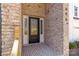 Elegant front door with glass panels and brick surround, providing a warm and inviting entrance at 606 Saint Cloud Dr, Statesville, NC 28625