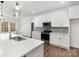 This kitchen features white cabinetry, stainless steel appliances, a kitchen island, and modern pendant lighting at 606 Saint Cloud Dr, Statesville, NC 28625