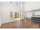 Bright living room with hardwood floors, high ceilings, and sliding glass door access to the outdoor space at 606 Saint Cloud Dr, Statesville, NC 28625