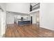 Open-concept living space with modern kitchen island, hardwood floors, and access to the upper floor at 606 Saint Cloud Dr, Statesville, NC 28625