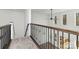 Stairwell with carpeted stairs and decorative iron railing leading to a light-filled upper level at 606 Saint Cloud Dr, Statesville, NC 28625