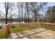 Back of house featuring a wooden deck overlooking a pond with fountains surrounded by trees at 6420 Tunston Ln, Charlotte, NC 28269