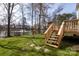 Beautiful backyard view of deck, mature trees, and a scenic pond at 6420 Tunston Ln, Charlotte, NC 28269