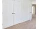 Bedroom showcasing carpet, double closets, and an open doorway, with neutral walls at 6420 Tunston Ln, Charlotte, NC 28269