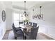 Bright dining room with stylish lighting fixtures, a decorative wine rack, and seating for six at 6420 Tunston Ln, Charlotte, NC 28269