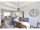 Elegant dining room showcases a stylish chandelier, a decorative clock and seating for four at 6420 Tunston Ln, Charlotte, NC 28269