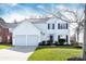 Charming two-story home with a well-manicured lawn and a two-car garage at 6420 Tunston Ln, Charlotte, NC 28269