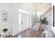 Bright entryway featuring hardwood floors, wainscoting, and staircase access at 6420 Tunston Ln, Charlotte, NC 28269
