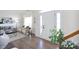 Inviting foyer with hardwood floors, a modern rug, and a view of the living area at 6420 Tunston Ln, Charlotte, NC 28269
