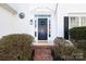 Elegant front entrance featuring a beautiful blue door and lovely landscaping at 6420 Tunston Ln, Charlotte, NC 28269